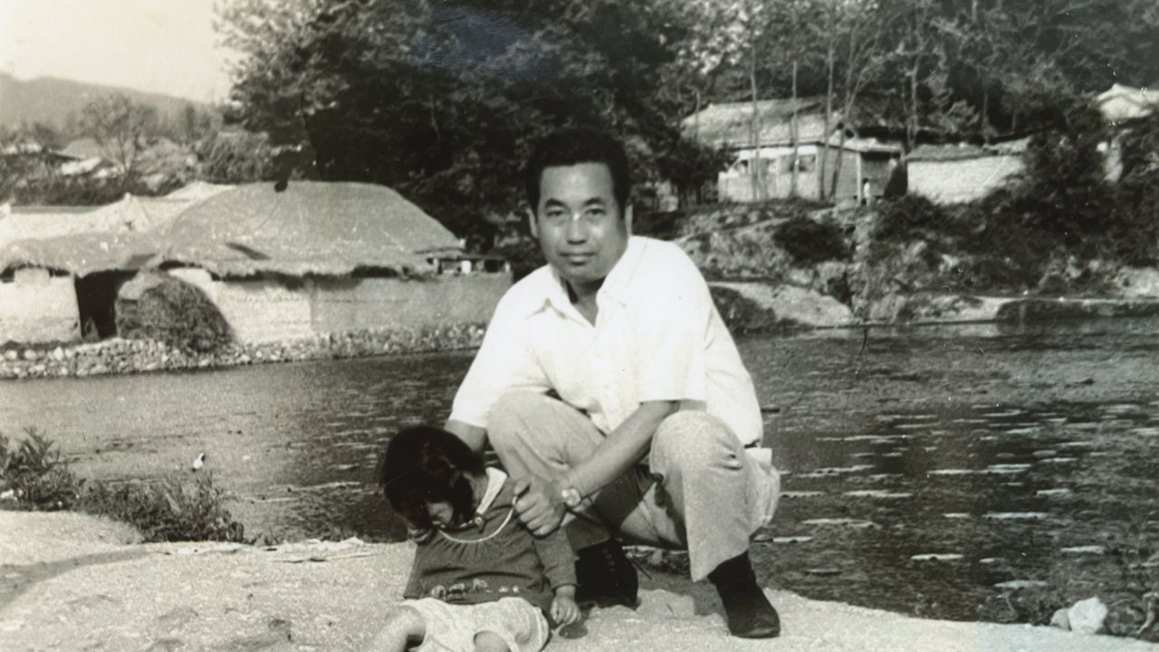 a man sitting with a little girl